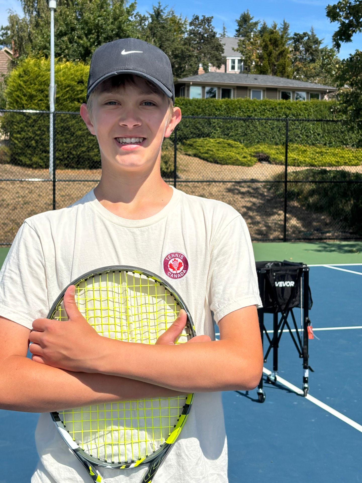 Head coach Oliver Talbot holding his racket on court in Victoria